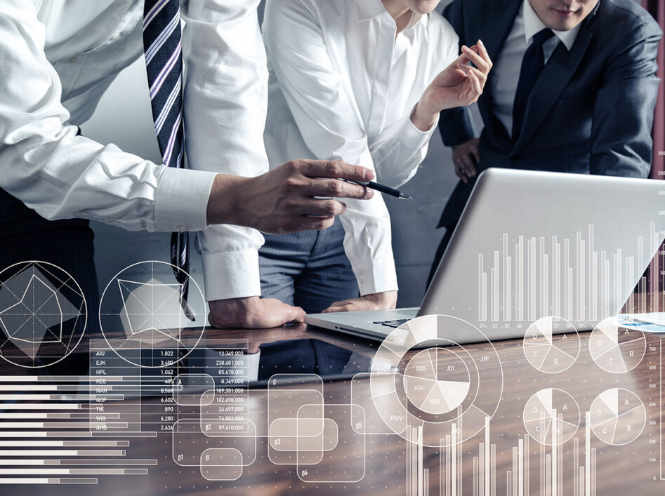 Professionals around a laptop, reviewing data.