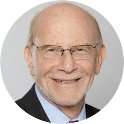 Headshot of Len Waverman, a smiling man with greying hair, glasses and a black suit.